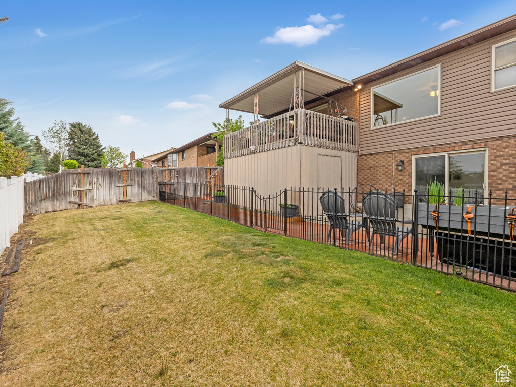 View of yard with a balcony