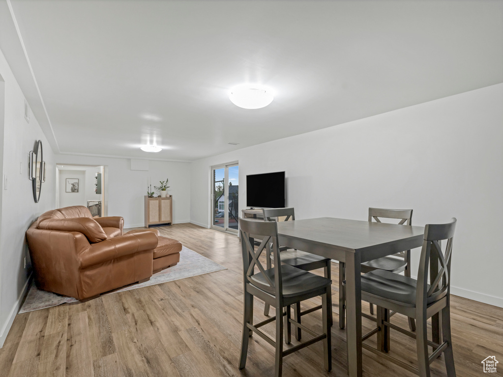 Dining space with baseboards and light wood-style floors