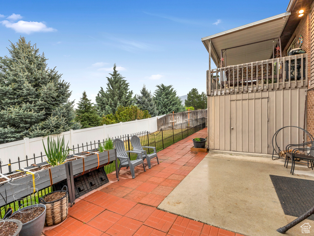 View of patio / terrace with a garden and a fenced backyard