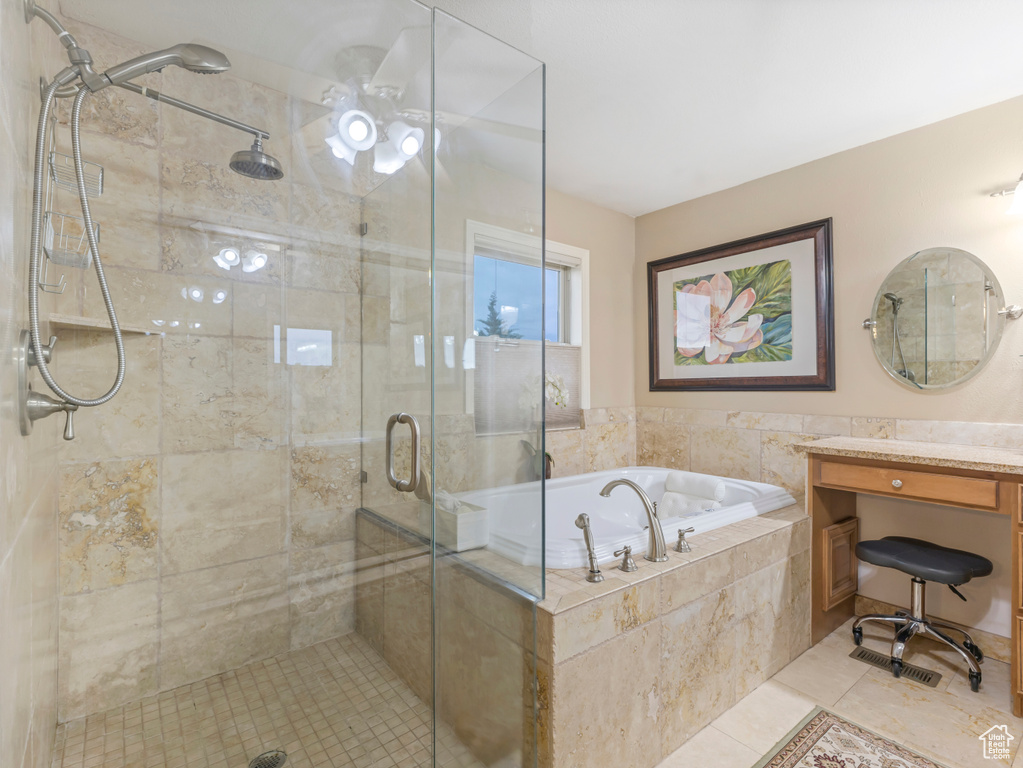 Full bathroom featuring a shower stall, a garden tub, tile patterned floors, and vanity