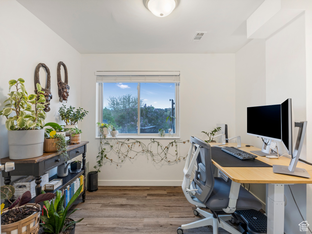 Home office featuring wood finished floors and baseboards