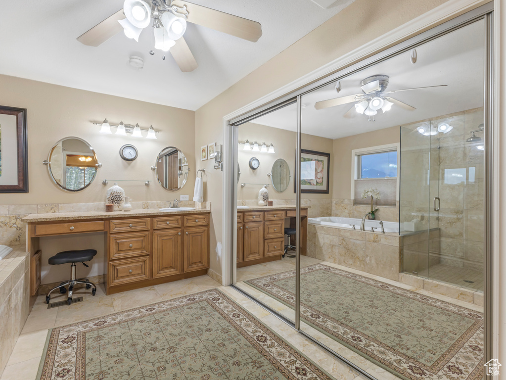 Full bath with a ceiling fan, vanity, a bath, a stall shower, and tile patterned flooring