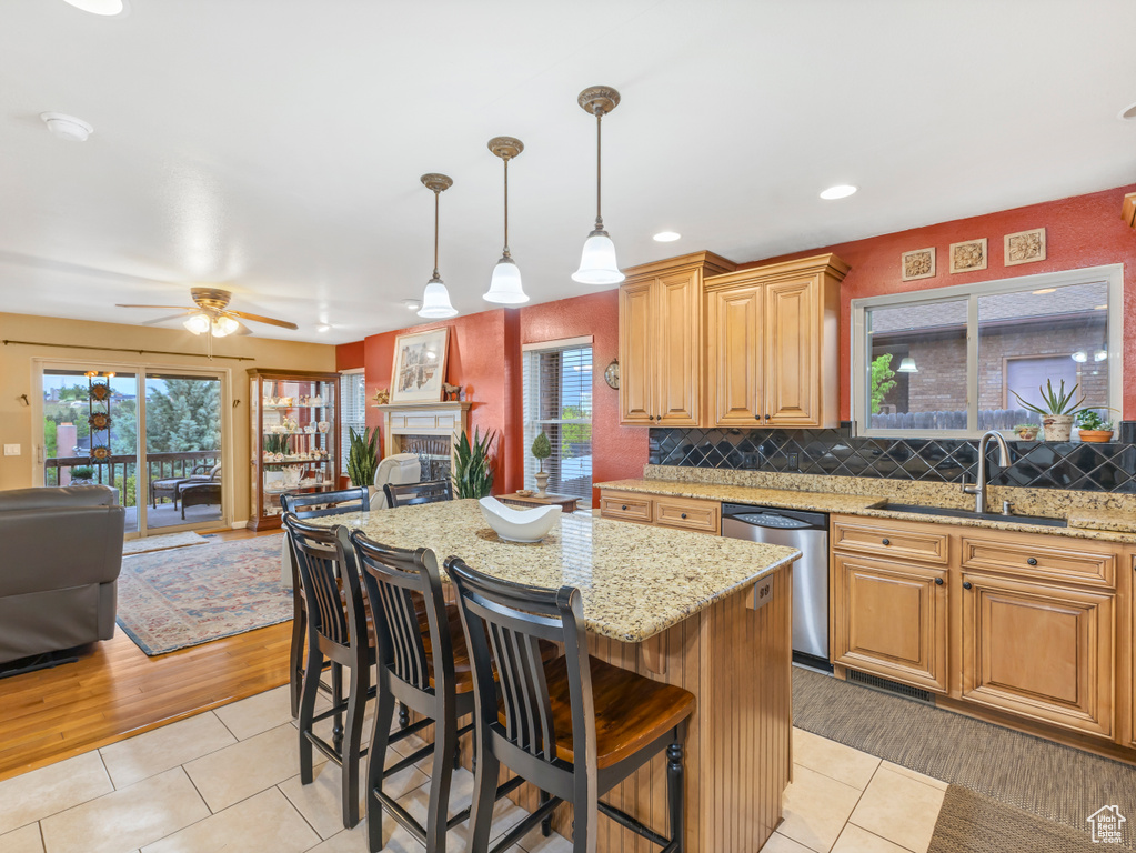 Kitchen featuring a sink, dishwasher, open floor plan, light tile patterned flooring, and recessed lighting