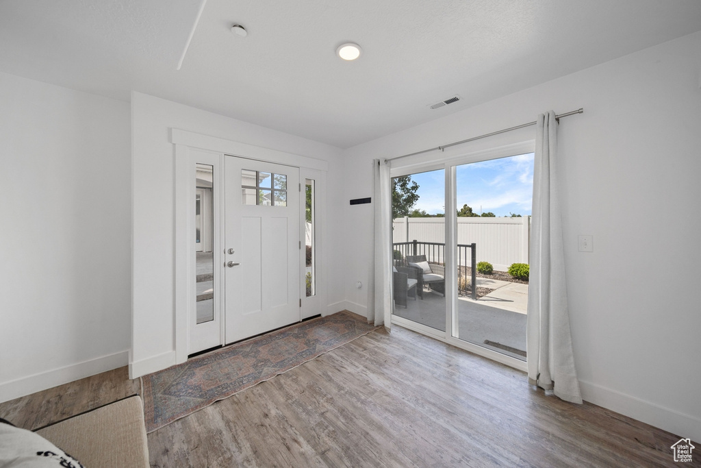 Foyer entrance featuring wood finished floors and baseboards