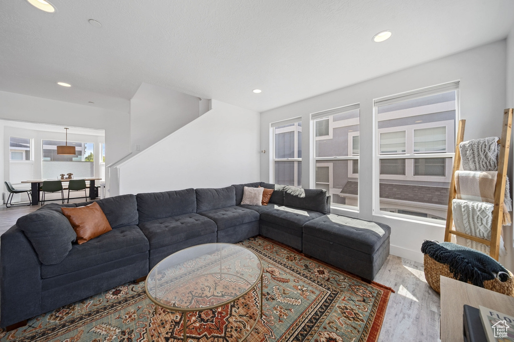Living room with wood finished floors and recessed lighting