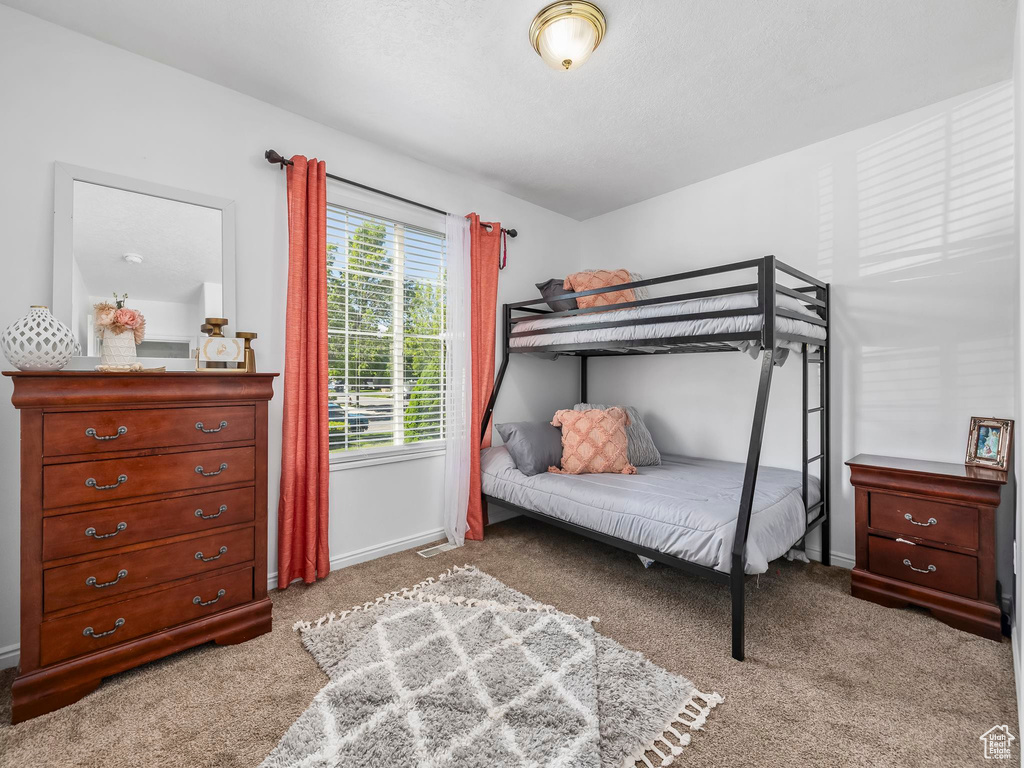 Bedroom featuring carpet flooring and baseboards