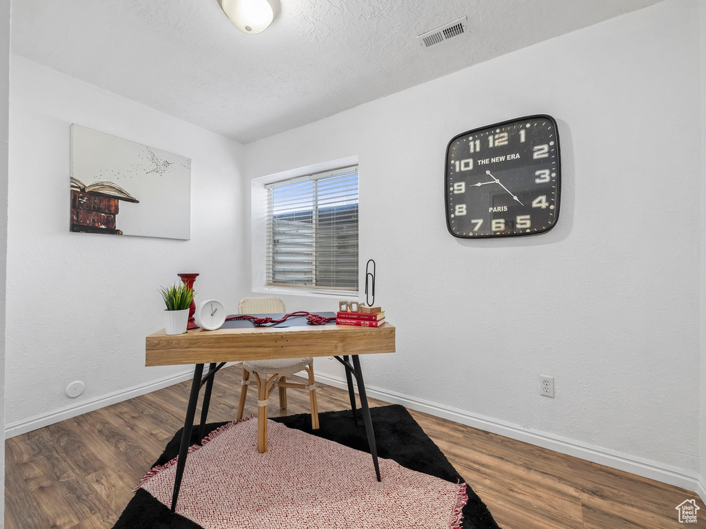 Office area featuring wood finished floors and baseboards
