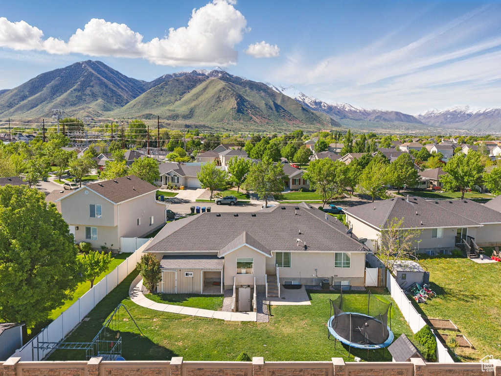 Aerial perspective of suburban area featuring a mountainous background