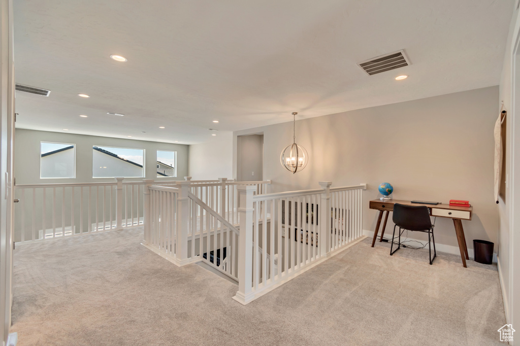 Hallway featuring carpet flooring, a chandelier, recessed lighting, an upstairs landing, and baseboards