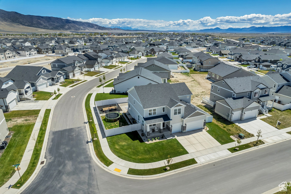 Aerial perspective of suburban area featuring a mountain backdrop