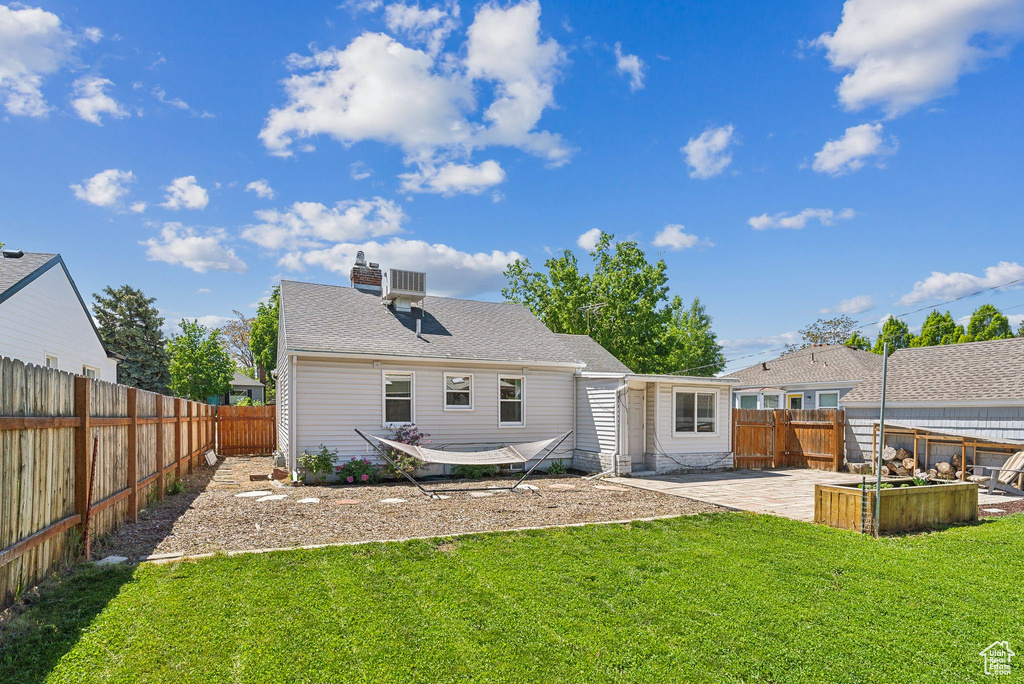 Back of property with a patio, a garden, and a chimney