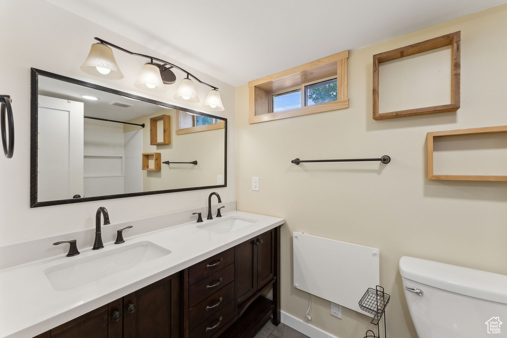 Bathroom with toilet and double vanity