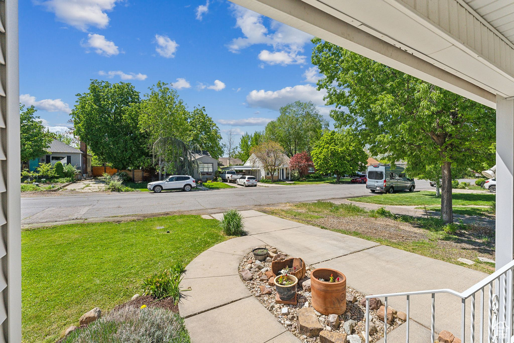 View of green lawn with a residential view