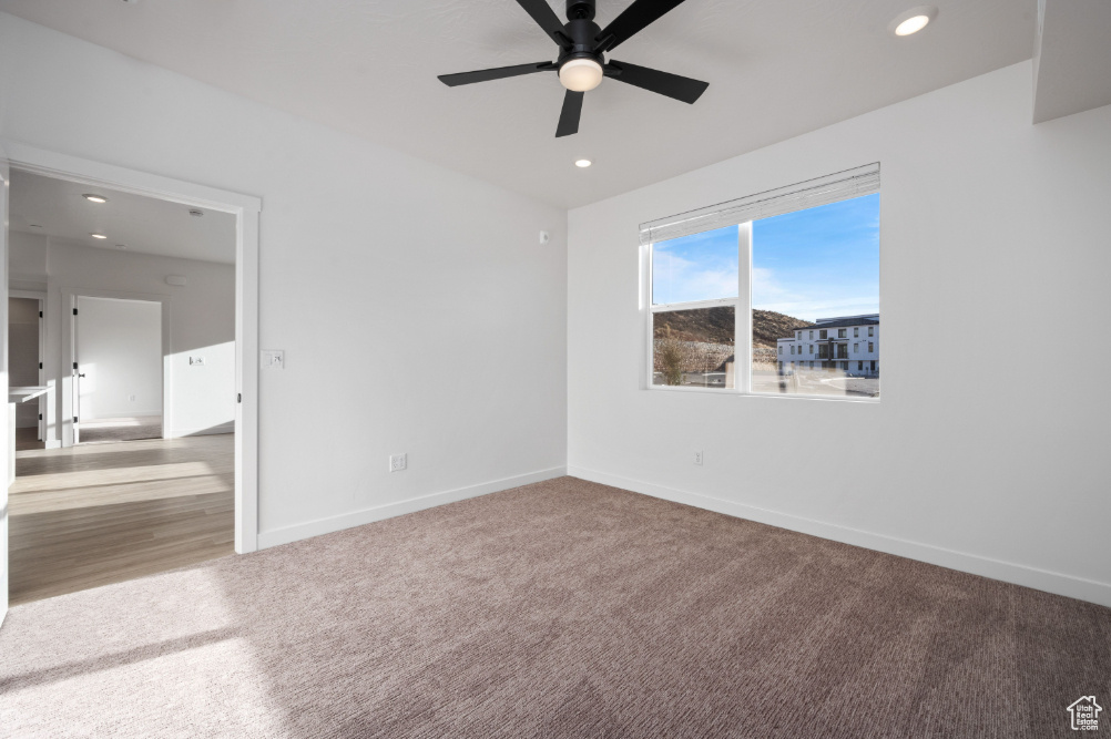 Unfurnished bedroom featuring carpet flooring, baseboards, ceiling fan, and recessed lighting