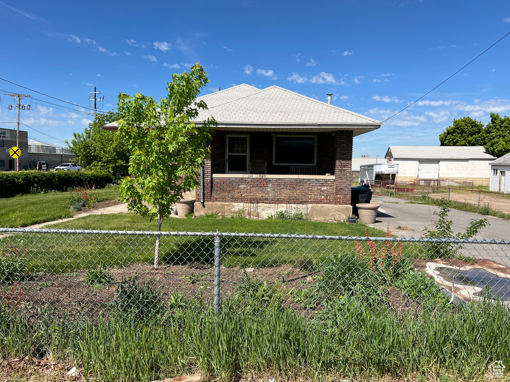 Back of property featuring brick siding