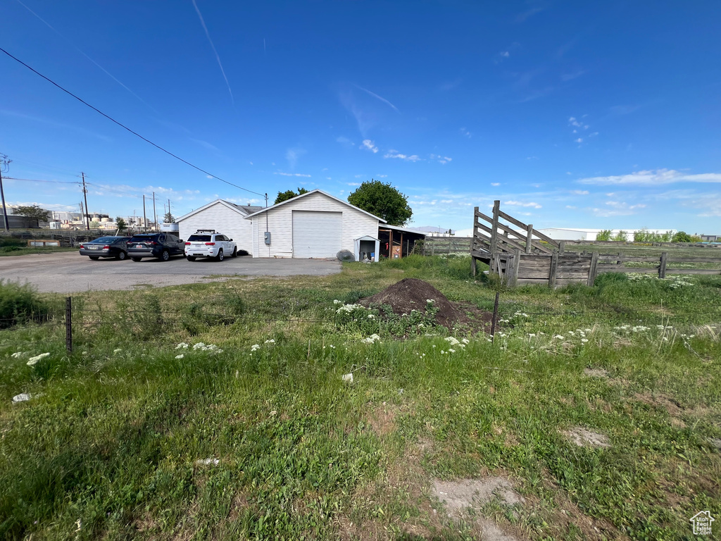 View of yard featuring fence and a detached garage