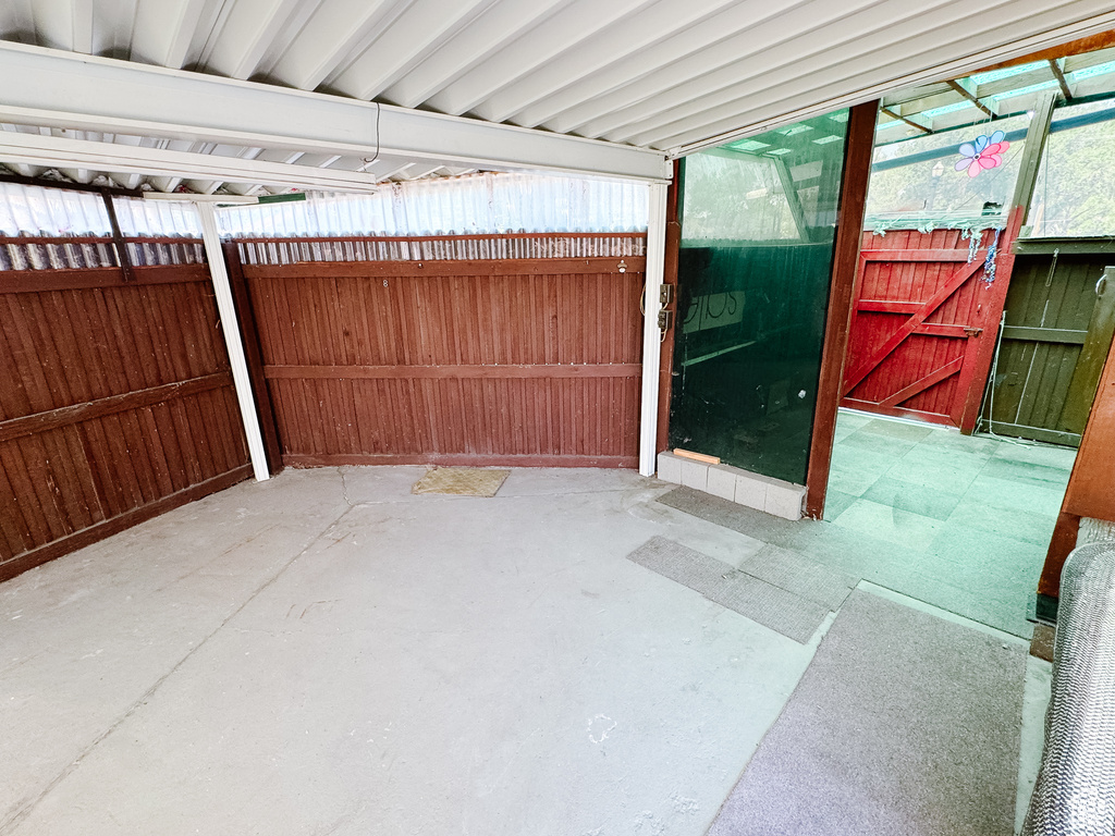 View of patio featuring fence
