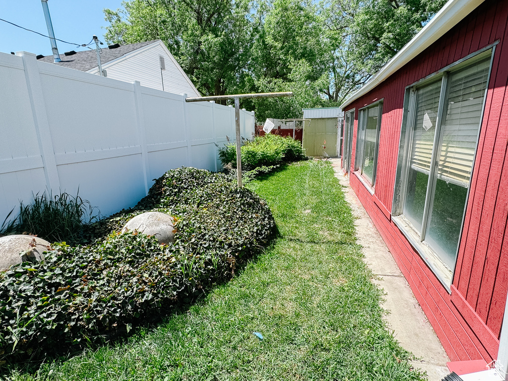 View of yard featuring a storage shed and an outbuilding
