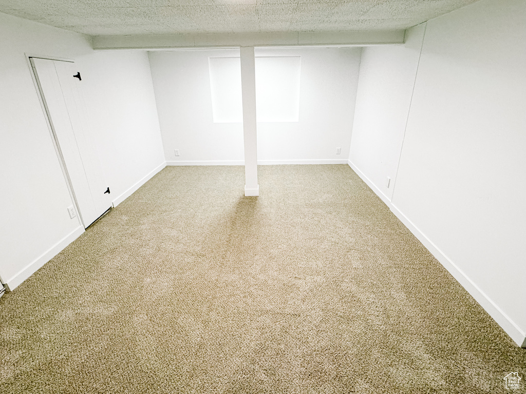 Finished below grade area featuring carpet flooring and baseboards