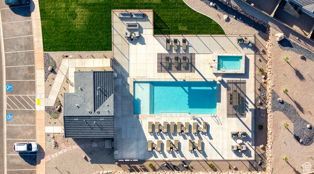 Aerial view of property and surrounding area featuring a pool area