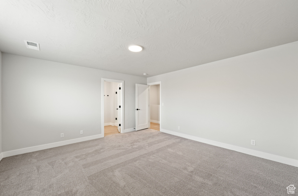 Unfurnished bedroom with baseboards and carpet