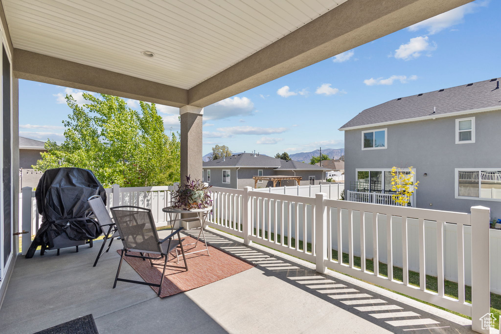 View of patio / terrace featuring fence, a residential view, and a grill