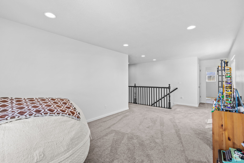 Bedroom with carpet floors, baseboards, and recessed lighting