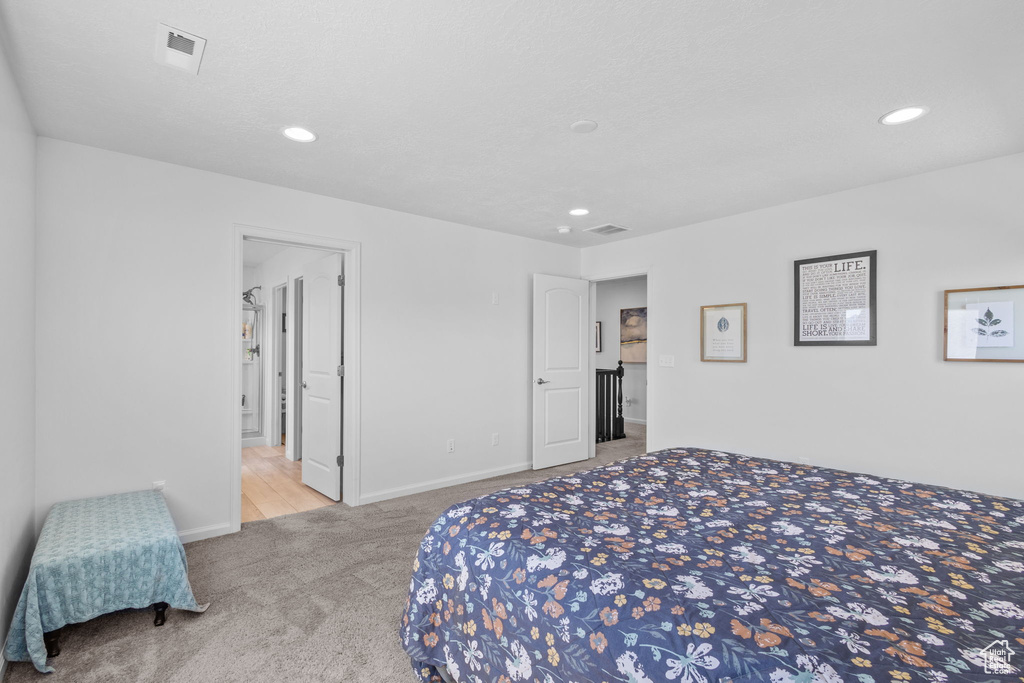 Carpeted bedroom with recessed lighting and baseboards