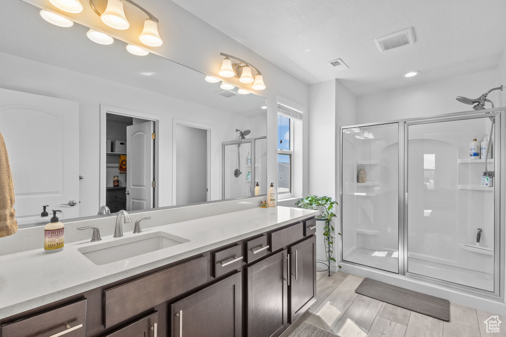 Bathroom featuring a stall shower and vanity