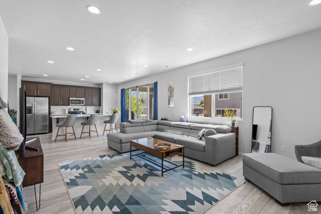 Living room featuring recessed lighting and light wood finished floors