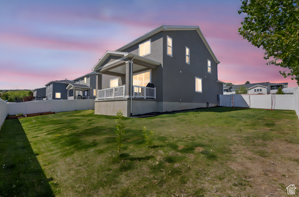 Rear view of house with a gate and stucco siding