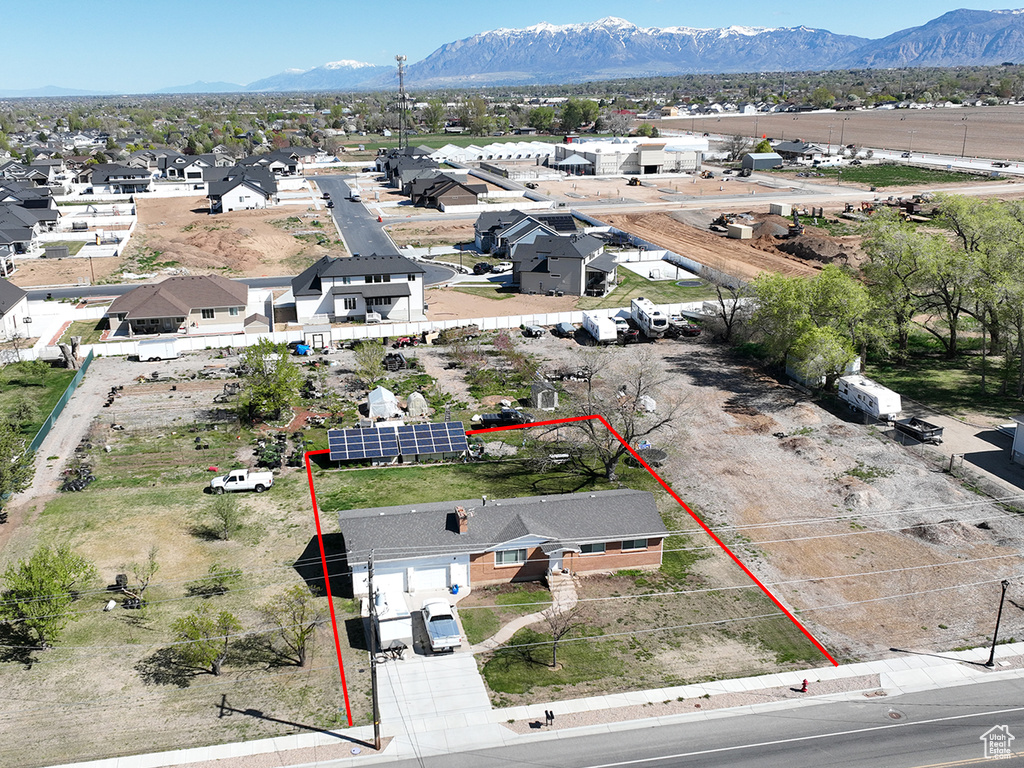 Aerial perspective of suburban area featuring property parcel outlined and a mountainous background