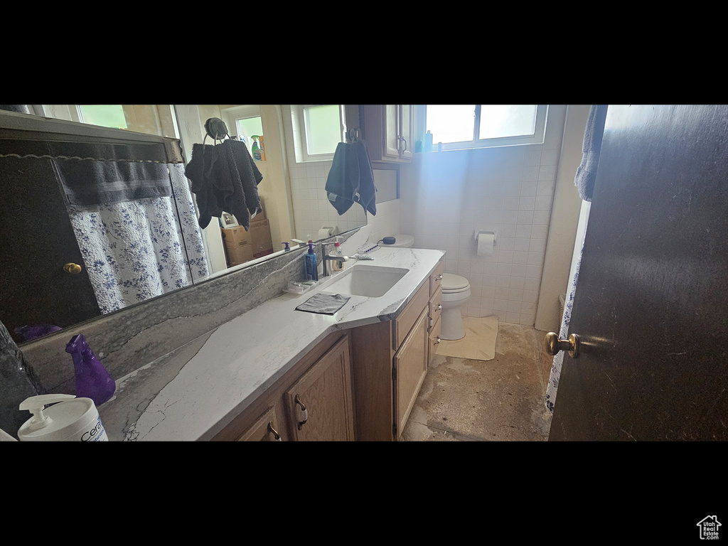 Full bath with toilet and vanity