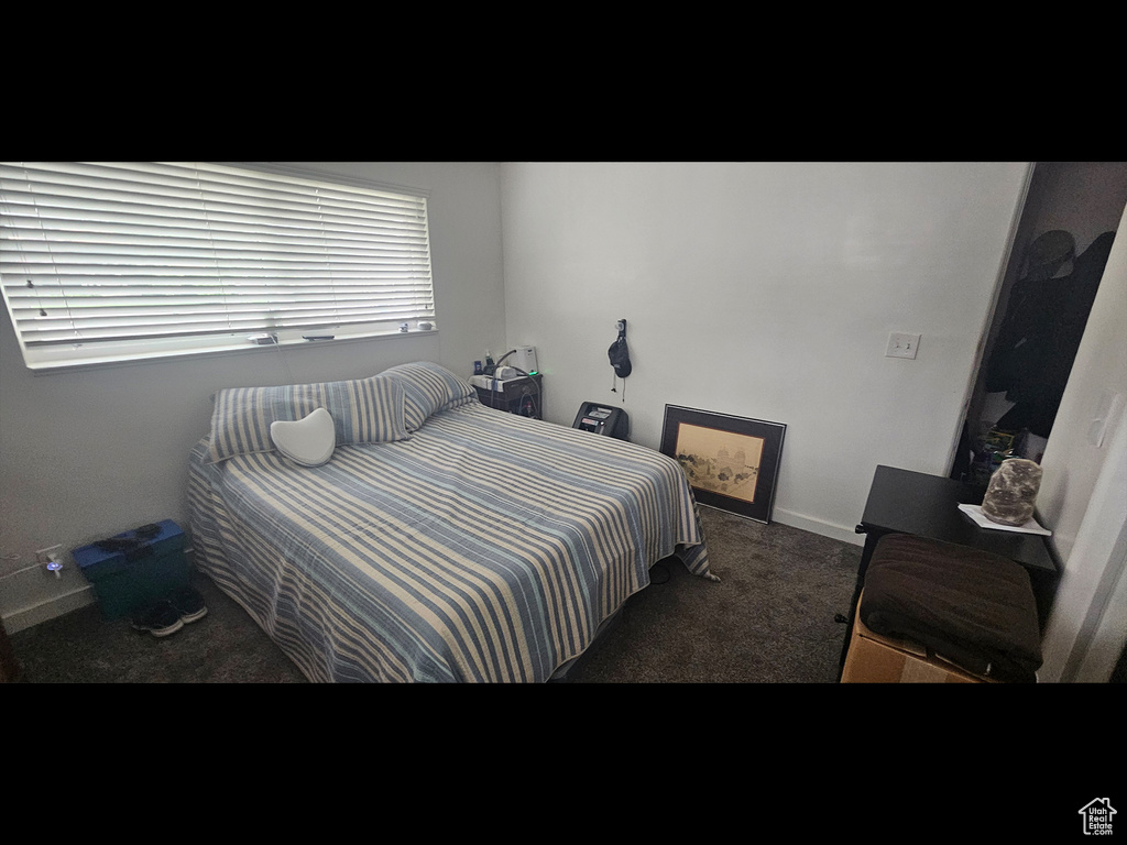 Carpeted bedroom with baseboards