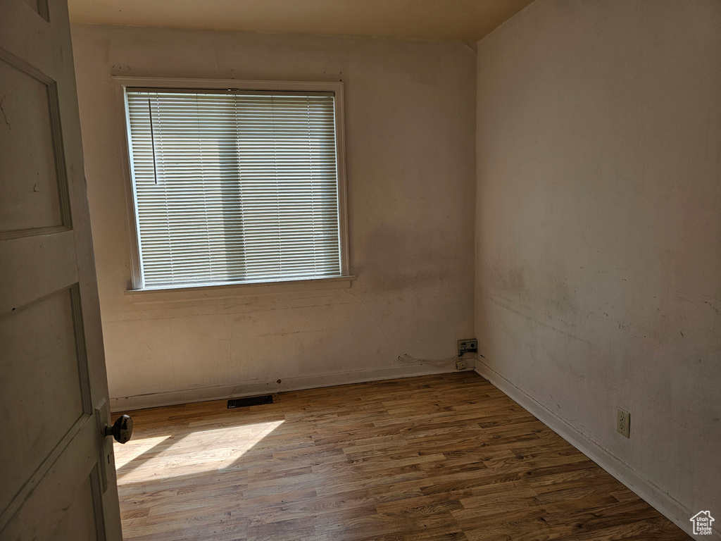 Empty room with wood finished floors and plenty of natural light