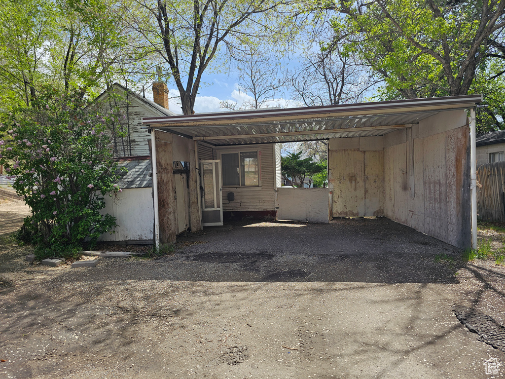 View of vehicle parking with driveway and fence