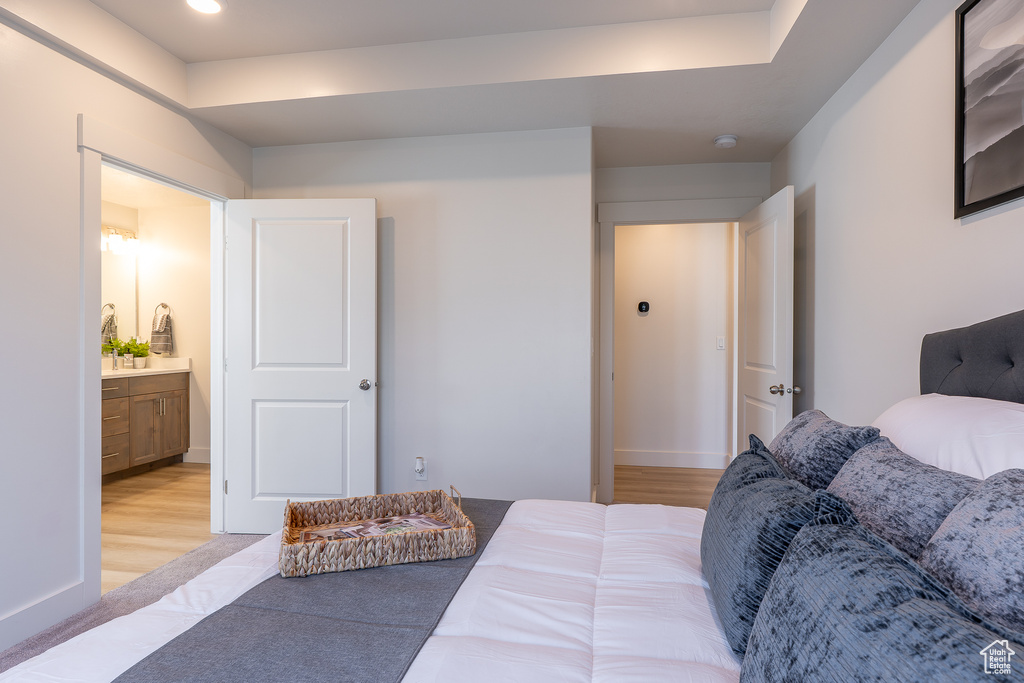 Bedroom featuring light wood-style floors, recessed lighting, and ensuite bathroom