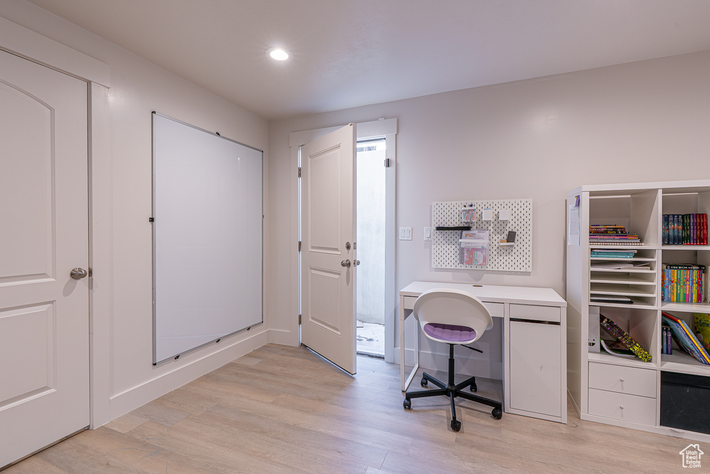 Office with light wood finished floors, recessed lighting, and baseboards