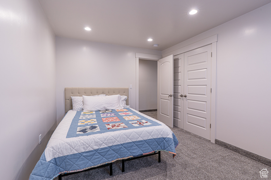 Bedroom featuring recessed lighting, carpet flooring, and a closet