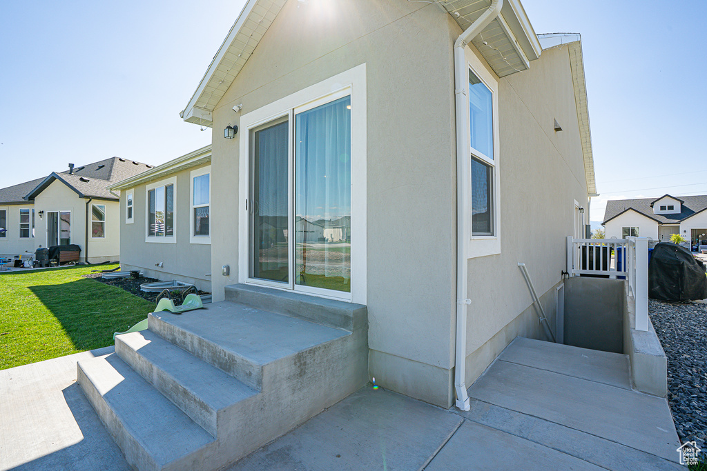 View of home\'s exterior featuring a yard and stucco siding