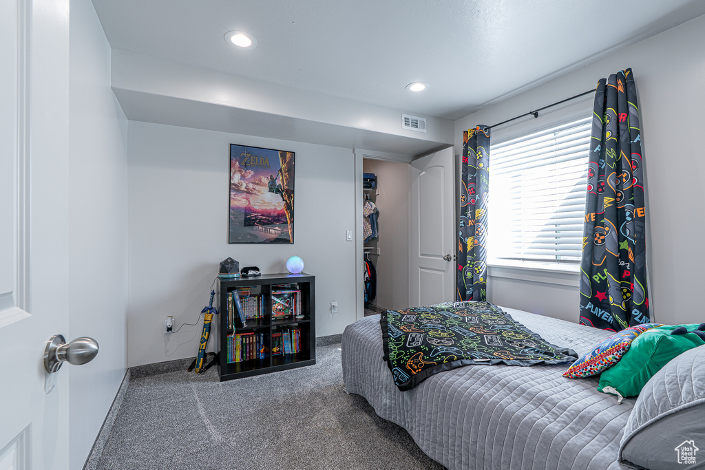 Bedroom featuring carpet, a spacious closet, baseboards, and recessed lighting