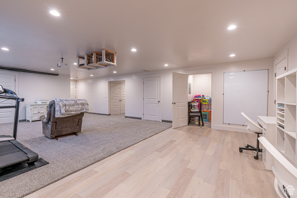 Workout room featuring recessed lighting, light wood-style floors, and baseboards