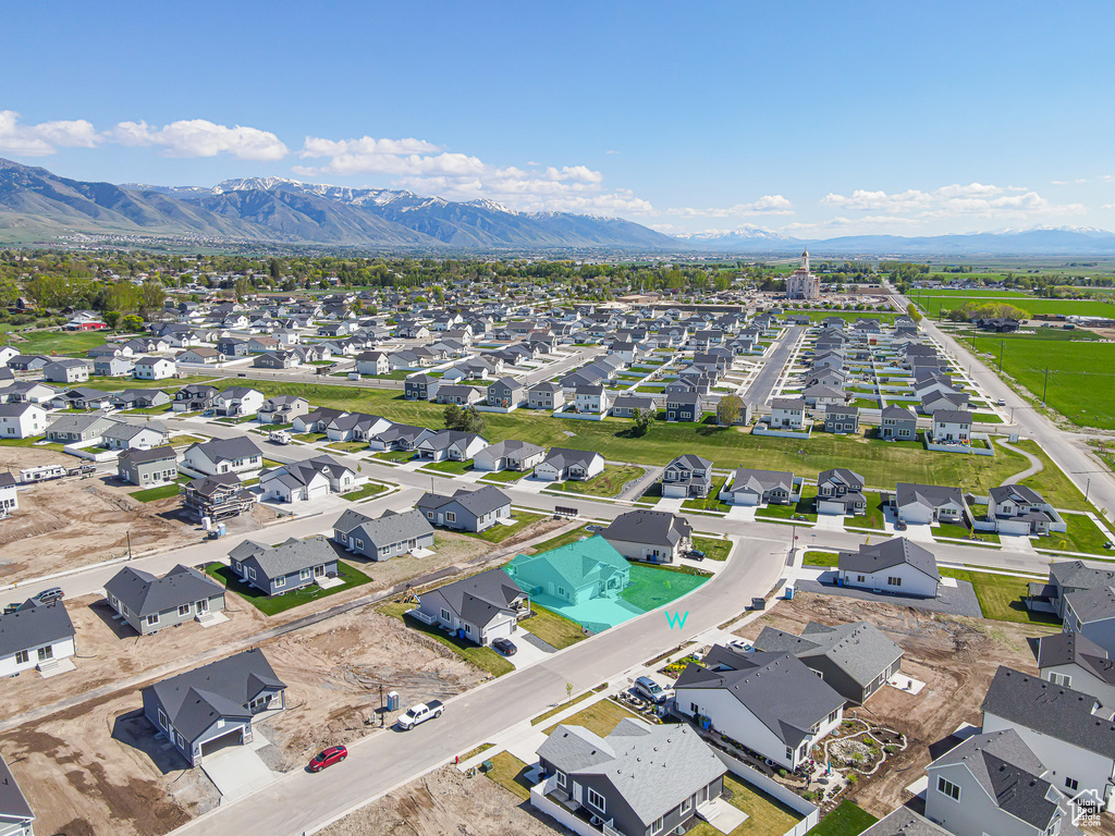 Aerial perspective of suburban area featuring a mountain backdrop