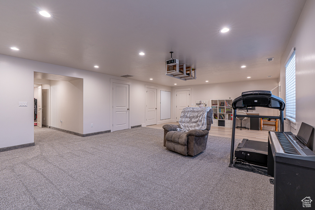 Living room with recessed lighting, carpet flooring, and baseboards