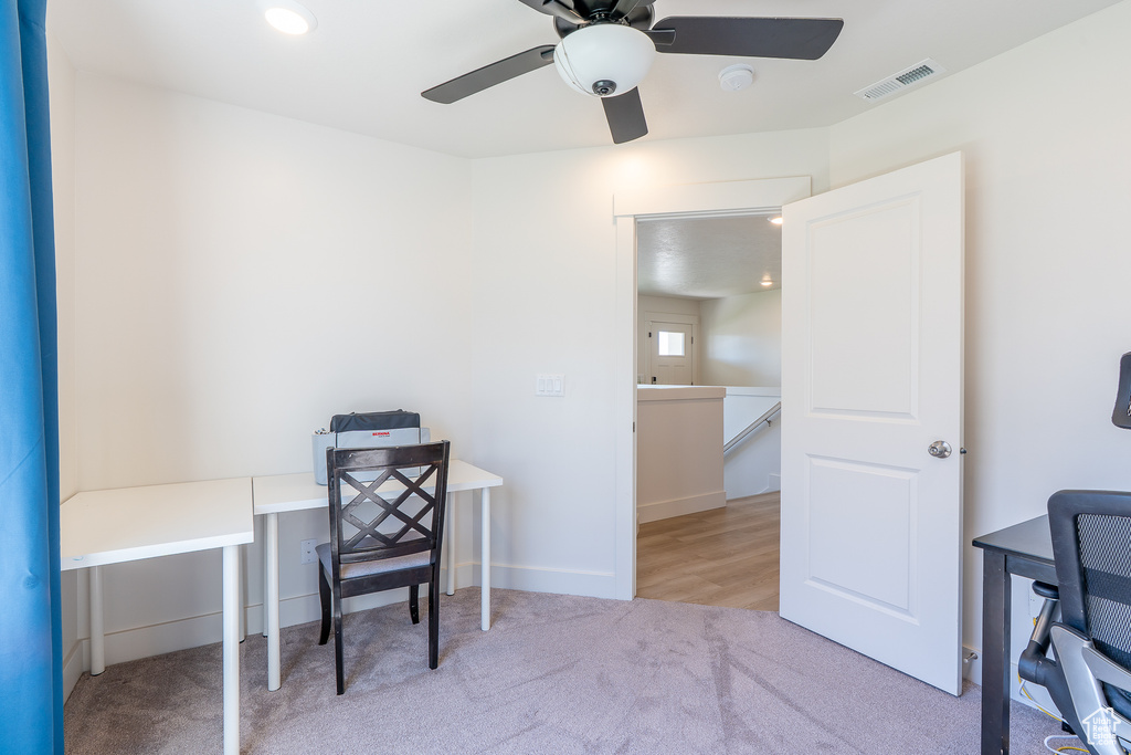 Office area featuring carpet and ceiling fan