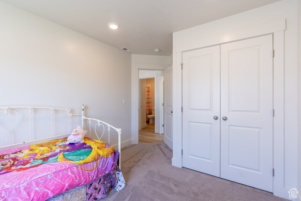 Carpeted bedroom with a closet, baseboards, and recessed lighting