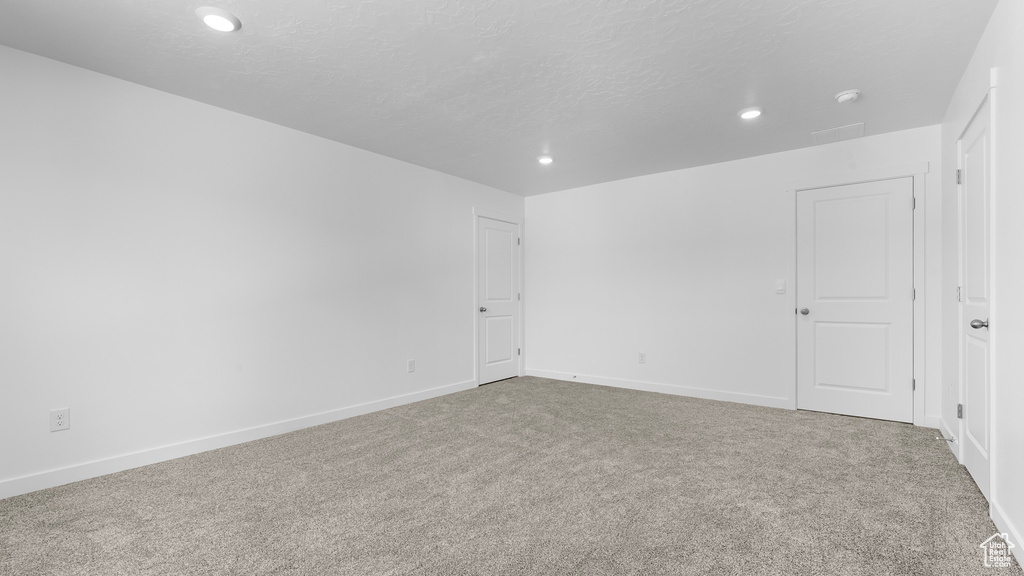 Unfurnished room featuring recessed lighting, carpet floors, baseboards, a smoke detector, and a textured ceiling