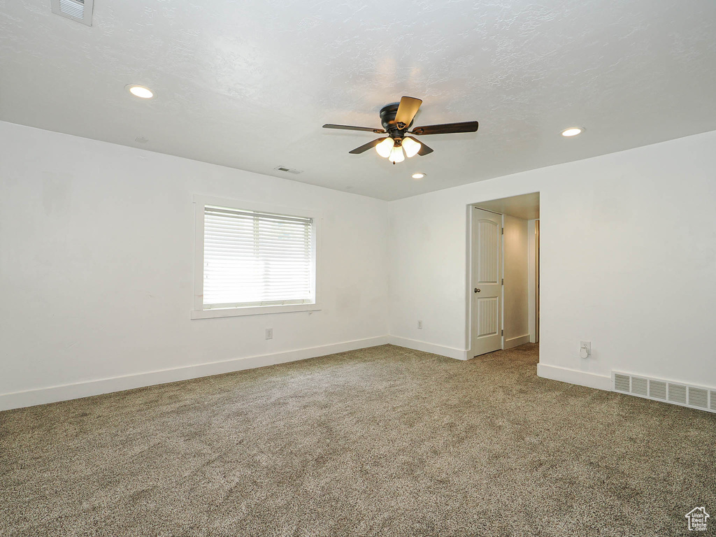 Spare room featuring a ceiling fan, carpet floors, recessed lighting, and baseboards