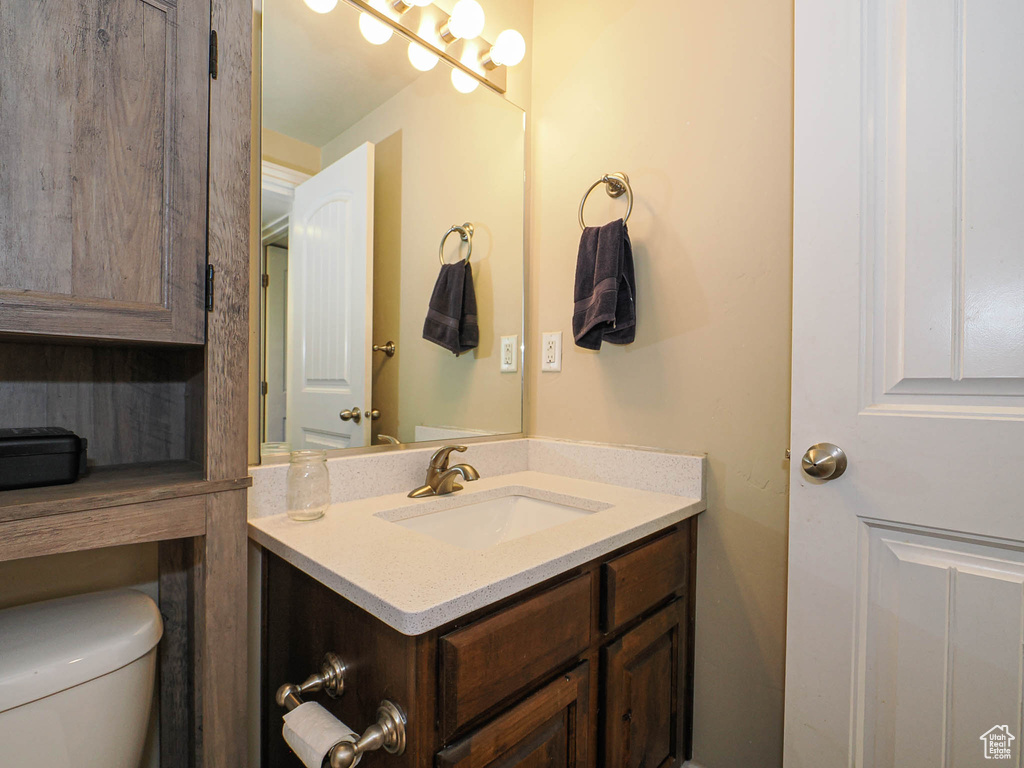Half bath with vanity and toilet