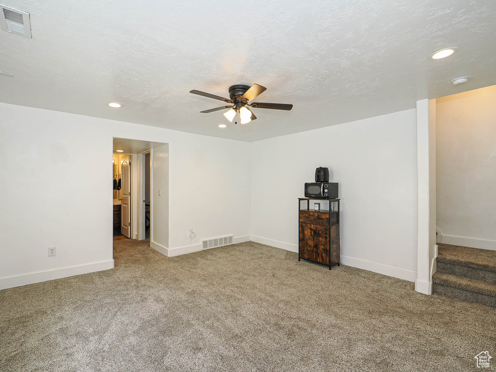 Empty room with recessed lighting, a ceiling fan, carpet flooring, baseboards, and a smoke detector